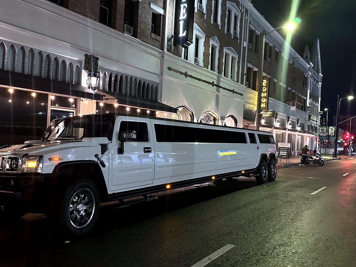 Six-wheel Hummer super stretch limousine at night
